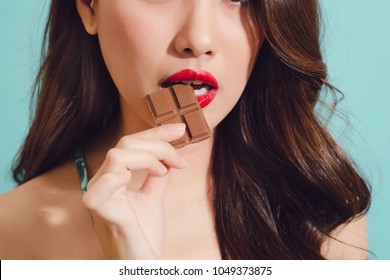 Attractive Young Asian Woman Eating Chocolate, Closeup