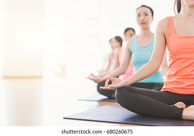 Attractive Young Asian Woman Group Exercising And Sitting In Yoga Lotus Position In Yoga Classes