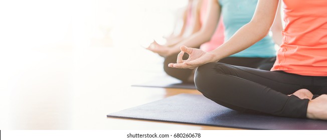 Attractive Young Asian Woman Group Exercising And Sitting In Yoga Lotus Position In Yoga Classes