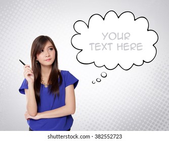Attractive young Asian woman staring at white comic cloud on top-right. Creative imaginative image for business / education concept with copy space