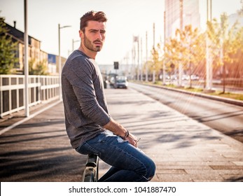 Attractive young bearded man portrait in urban environment, in a street, looking at camera - Shutterstock ID 1041887470