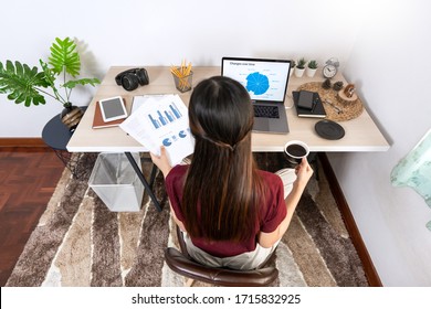 Attractive young beautiful asian woman Entrepreneur or freelancer working at home with laptop business reports and online communications on living room sofa, working remotely access concept - Shutterstock ID 1715832925