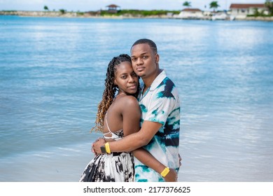 Attractive Young Black Couple Embrace While Standing On The Beach