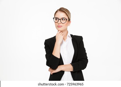 Attractive Young Blonde Business Woman In Eyeglasses Holding Hand Near Chin And Looking Away Over White Background