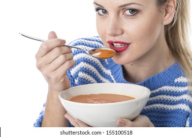 Attractive Young Blonde Caucasian Woman, Eating A Bowl Of Hot Winter Warming Tomato Soup, Isolated On White