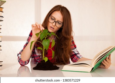 Attractive Young Botany Student With Seedlnng And Books