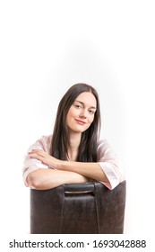 Attractive Young Brunette Woman Wearing A Pink Nightgown, Sitting On Chair With Crossed Arms Smiling. Royalty Free Stock Photo.