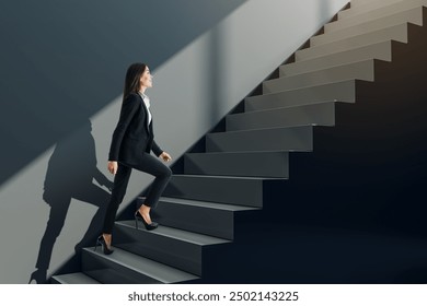 Attractive young businesswoman climbing black stairs and concrete wall. Success, worker, career growth and up concept