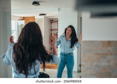 Attractive Young Businesswoman Getting Dressed For Work While Still At Home In The Morning