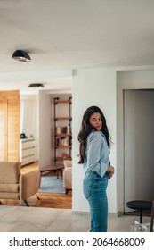 Attractive Young Businesswoman Getting Dressed For Work While Still At Home In The Morning