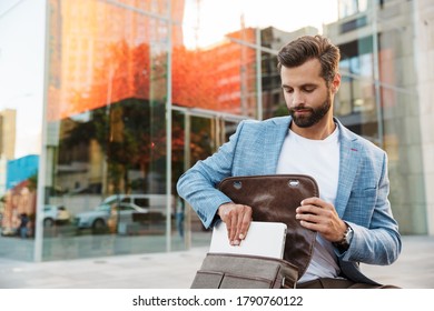 Attractive Young Bussiness Man Getting Ready To Work On Laptop Computer While Sitting Outdoors