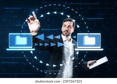 Attractive young caucasian businessman with pad using creative digital data transfer and exchange folders on dark background. Backup data, virtual document storage or loading on cloud service - Powered by Shutterstock