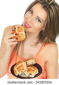 Attractive Young Caucasian Woman, With Brunette Hair, Eating Traditional Easter Celebration Hot Cross Buns, Isolated On White