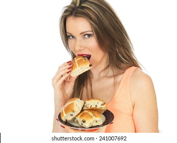 Attractive Young Caucasian Woman, With Brunette Hair, Eating Traditional Easter Celebration Hot Cross Buns, Isolated On White