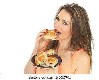 Attractive Young Caucasian Woman, With Brunette Hair, Eating Traditional Easter Celebration Hot Cross Buns, Isolated On White With Copy Space