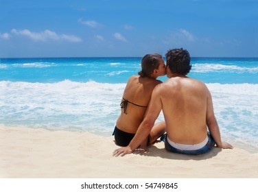 An Attractive Young Couple Enjoying A Romantic Getaway On The Beach