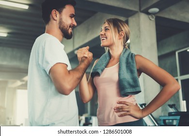 Attractive young couple handshaking after workout in fitness gym., Portrait of man and woman couple love are working out training together., Couple fitness and healthy concept. - Powered by Shutterstock