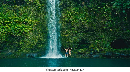 Attractive young couple having fun relaxing at beautiful waterfall
