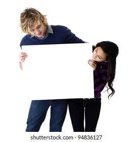 Attractive Young Couple Holding A Blank Sign