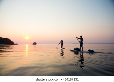 Attractive Young Couple Stand Up Paddle Boarding, Active Beach Lifestyle