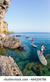 Attractive Young Couple Stand Up Paddle Boarding, Active Beach Lifestyle