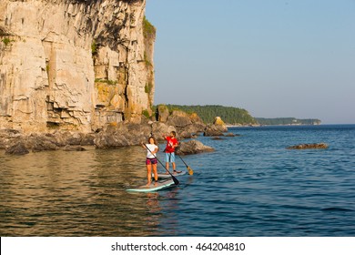 Attractive Young Couple Stand Up Paddle Boarding, Active Beach Lifestyle