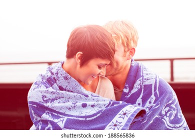 Attractive Young Couple At Sunset Sitting In A Truck Bed At The Beach In California