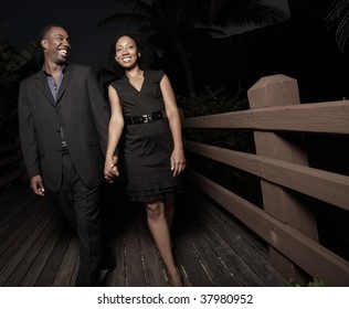 Attractive Young Couple Walking At Night