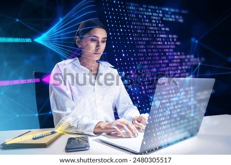 Attractive young european businesswoman using laptop at desk with creative big data lines on dark background. Technology and innovation concept. Double exposure