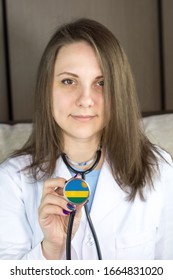 Attractive Young Female Doctor. Focus On The Rwanda Flag Stethoscope.