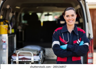 Attractive Young Female Emergency Medical Service Worker In Front Of Ambulance