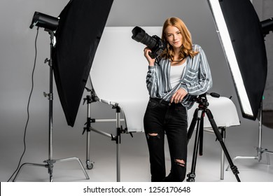 attractive young female photographer working in professional photo studio  - Powered by Shutterstock