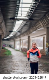 Attractive Young Female Running Outside On A Cold Winter Day. Healthy Lifestyle. Winter Fitness.