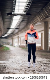 Attractive Young Female Running Outside On A Cold Winter Day. Healthy Lifestyle. Winter Fitness.