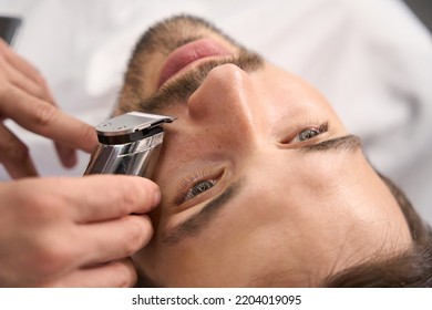 Attractive Young Gentleman Using Service Of Barber For Moustache Trim