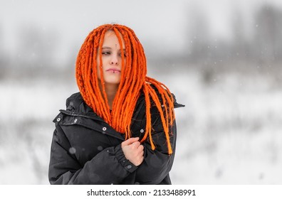 Attractive young ginger-haired woman in wintertime. Shallow DOF
