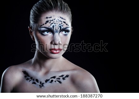 Attractive young girl with make-up snow leopard close-up portrait