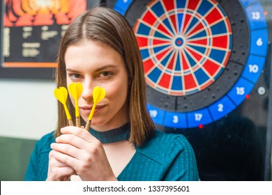 Attractive Young Girl Playing Darts