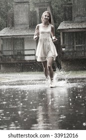 Attractive Young Girl Running In The Rain