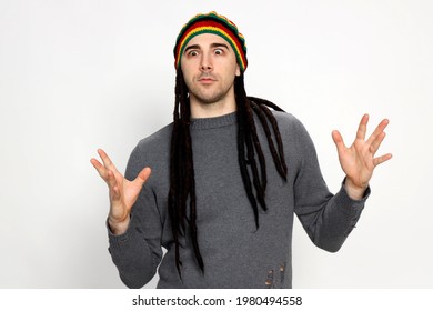 Attractive Young Guy With Very Long Dreadlocks And A Cap Is Posing In Studio. Style, Trends, Fashion Concept.