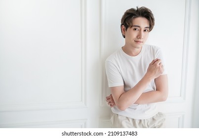 Attractive Young Handsome Smiling Face Positive Asian, Korean Happy Casual Man, Stay Home Minimal Lifestyle. Closeup Portrait Of Asia Middle Age 20s Man Wearing White Shirt In Studio. Young Model Boy 