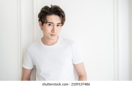 Attractive young handsome smiling face positive asian, korean happy casual man, stay home minimal lifestyle. Closeup portrait of asia middle age 20s man wearing white shirt in studio. Young model boy  - Shutterstock ID 2109137486