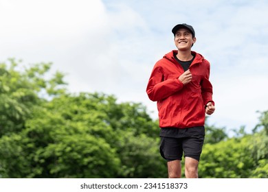 Attractive Young indian man wearing sportswear running on track at sport stadium. Asian Fit man jogging outdoor cross the finish line. Exercise in the morning. Healthy and active lifestyle concept. - Shutterstock ID 2341518373