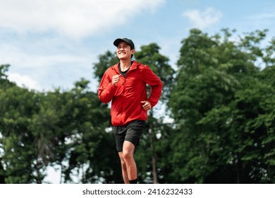 Attractive Young indian man wearing sportswear running on track at sport stadium. Asian Fit man jogging outdoor cross the finish line. Exercise in the morning. Healthy and active lifestyle concept. - Powered by Shutterstock