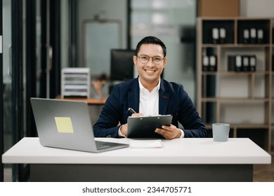 Attractive young lawyer in modern office Business man and lawyers discussing contract papers laptop and tablet with brass scale on  desk in modern office. Law, legal services, advice,

 - Powered by Shutterstock