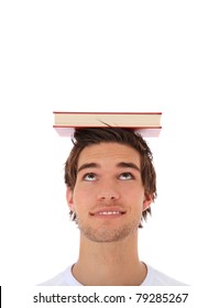 Attractive Young Man Balancing A Book On His Head. Extra Copy Space On Top. All On White Background.