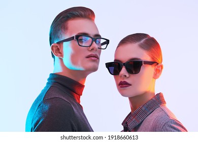 Attractive Young Man And Beautiful Young Woman  Are Posing Together In Stylish Glasses. Optics Style. Fashion Studio Shot. 