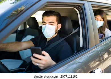 Attractive Young Man With A Face Mask Working As A Ride Share Driver During The Coronavirus Pandemic