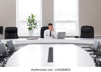 Attractive Young Man In The Office In A Conference Room Alone