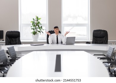 Attractive Young Man In The Office In A Conference Room Alone